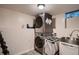 Efficient laundry room with stacked washer and dryer, stainless steel sink, and a window for natural light at 4329 S Clarkson St, Englewood, CO 80113