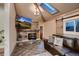 Living room boasts a stone fireplace, vaulted ceiling with a skylight, and a comfortable leather sofa at 4329 S Clarkson St, Englewood, CO 80113