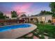 Inviting backyard pool with a well-maintained lawn and a covered patio, perfect for summertime fun at 4329 S Clarkson St, Englewood, CO 80113