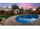 Beautiful backyard pool area with a well-maintained pool, sunroom, shed and landscaped surroundings at 4329 S Clarkson St, Englewood, CO 80113