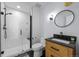 Modern bathroom with a walk-in shower, floating vanity, and black accents at 7401 Deerfield Rd, Longmont, CO 80503