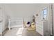 Cozy bedroom with crib, dresser, and charming window at 7401 Deerfield Rd, Longmont, CO 80503