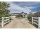 Stunning two-story home with circular driveway and white fencing at 7401 Deerfield Rd, Longmont, CO 80503