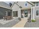 Home exterior with covered porch, outdoor dining set, and walkway at 7401 Deerfield Rd, Longmont, CO 80503