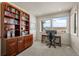 Home office with built-in shelving, a desk, and views of mountains at 7401 Deerfield Rd, Longmont, CO 80503