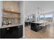Modern kitchen with a stylish bar, black cabinetry, and a wine cooler at 7401 Deerfield Rd, Longmont, CO 80503