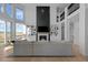 Spacious living room with a modern fireplace, built-in shelving, and hardwood floors at 7401 Deerfield Rd, Longmont, CO 80503