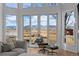Living room with wall-to-wall windows showcasing mountain views, comfortable seating, and a fireplace at 7401 Deerfield Rd, Longmont, CO 80503