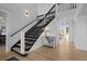 Elegant staircase with black spindles and light wood flooring at 7401 Deerfield Rd, Longmont, CO 80503