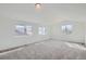 Bright and spacious bedroom with carpet and multiple windows at 6906 Kendrick Ln, Arvada, CO 80007