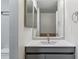 Bathroom vanity with gray cabinet, undermount sink, updated fixtures, and a mirrored medicine cabinet at 1202 S Troy St, Aurora, CO 80012