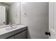 Updated bathroom with modern vanity and lighting fixtures at 1202 S Troy St, Aurora, CO 80012