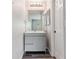 Bathroom featuring modern vanity, mirror, and lighting at 1202 S Troy St, Aurora, CO 80012