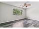 Bedroom featuring hardwood floors and a large window at 1202 S Troy St, Aurora, CO 80012