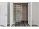 Walk-in closet with wire shelving and hardwood floors at 1202 S Troy St, Aurora, CO 80012