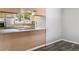 Kitchen area with stainless steel refrigerator and hardwood floors at 1202 S Troy St, Aurora, CO 80012