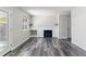 Open-concept living space featuring a fireplace and stylish gray laminate flooring at 1202 S Troy St, Aurora, CO 80012