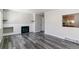 Spacious living area with a fireplace, gray floors, and neutral paint at 1202 S Troy St, Aurora, CO 80012