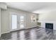 Cozy living room with laminate floors, fireplace, and bright double doors at 1202 S Troy St, Aurora, CO 80012