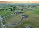 Aerial view showcasing a large lot with a long driveway and red barn-style home at 3124 Antelope Ridge Trl, Parker, CO 80138