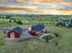 An aerial view of the home showing the fenced in backyard and the surrounding green pastures and community at 3124 Antelope Ridge Trl, Parker, CO 80138