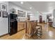 Basement features a bar area with stylish wood accents, sink, fridge, and stools at 3124 Antelope Ridge Trl, Parker, CO 80138