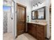 Bathroom featuring granite countertops, modern fixtures, decorative lighting, and walk-in shower at 3124 Antelope Ridge Trl, Parker, CO 80138