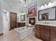 Luxurious bathroom with soaking tub, fireplace, granite countertops, and custom cabinetry at 3124 Antelope Ridge Trl, Parker, CO 80138