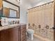 Cozy bathroom featuring a vanity, mirror and custom patterned shower curtain at 3124 Antelope Ridge Trl, Parker, CO 80138