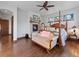 Cozy primary bedroom features four poster bed, fireplace, sitting area, and hardwood floors at 3124 Antelope Ridge Trl, Parker, CO 80138