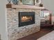 The cozy fireplace with a stone surround and a wooden mantle adds warmth to the room at 3124 Antelope Ridge Trl, Parker, CO 80138