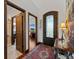 Inviting foyer with hardwood floors, an ornate front door, and views of an office and living spaces at 3124 Antelope Ridge Trl, Parker, CO 80138