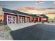 Home featuring a 4-car garage with white doors and beautiful stone accents at 3124 Antelope Ridge Trl, Parker, CO 80138