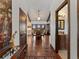 A beautiful view of the dining room from the hallway, featuring hardwood floors and elegant lighting at 3124 Antelope Ridge Trl, Parker, CO 80138