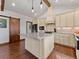 Bright kitchen with an island, tile backsplash, and modern appliances at 3124 Antelope Ridge Trl, Parker, CO 80138