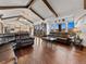 Spacious living room with hardwood floors, wood beams, and views of the beautiful backyard at 3124 Antelope Ridge Trl, Parker, CO 80138