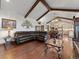 Open-concept living area showcasing hardwood floors, wood beams, and easy access to the kitchen at 3124 Antelope Ridge Trl, Parker, CO 80138