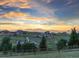 Scenic neighborhood view at sunset showcasing rolling hills and charming homes at 3124 Antelope Ridge Trl, Parker, CO 80138