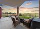 Covered patio with comfortable seating and fire pit, perfect for outdoor gatherings at 3124 Antelope Ridge Trl, Parker, CO 80138