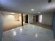 Large basement featuring both carpeted and tiled areas, showcasing flexible living space and modern flooring options at 11623 E Virginia Dr, Aurora, CO 80012