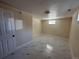 Basement room with bright, modern tile flooring and natural light, offering a clean, versatile living space at 11623 E Virginia Dr, Aurora, CO 80012