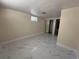 Basement room featuring modern tiled flooring and a built-in closet, creating a versatile and stylish space at 11623 E Virginia Dr, Aurora, CO 80012
