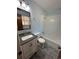 Bathroom featuring a vanity with dark countertops, white tiled shower and flooring at 11623 E Virginia Dr, Aurora, CO 80012