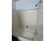 Bathroom with a shower-tub combination featuring white tiling and vintage fixtures at 11623 E Virginia Dr, Aurora, CO 80012