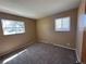 Carpeted bedroom featuring painted walls and two windows overlooking the outside at 11623 E Virginia Dr, Aurora, CO 80012