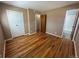 Bedroom featuring hardwood floors, a standard closet, and an adjoining bathroom at 11623 E Virginia Dr, Aurora, CO 80012