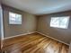 Hardwood floors shine in bedroom featuring two windows offering natural light at 11623 E Virginia Dr, Aurora, CO 80012