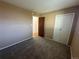 Bedroom featuring carpet floors, closet with panel doors, and an open doorway at 11623 E Virginia Dr, Aurora, CO 80012