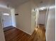 Entryway featuring hardwood floors, coat hooks, and an entry door with decorative glass at 11623 E Virginia Dr, Aurora, CO 80012