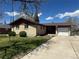 Quaint brick home with a cozy front yard, an attached one car garage and a yard swing at 11623 E Virginia Dr, Aurora, CO 80012